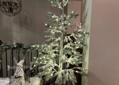 Mantel dressed with greenery, candles and stockings
